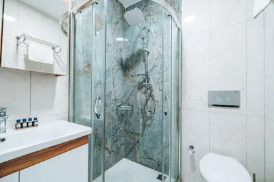 a shower with a glass door in a bathroom at Mysia Olympos Hotel in Bursa