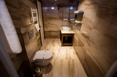 a bathroom with a toilet and a sink at Sea Garden Otel in Darıca