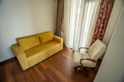 a living room with a couch and a chair at Sea Garden Otel in Darıca