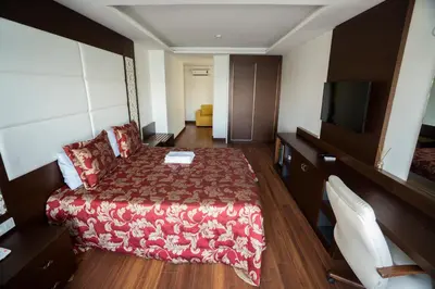 a hotel room with a bed and a flat screen tv at Sea Garden Otel in Darıca