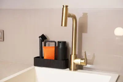 a kitchen sink with a faucet and an orange container at Tare Houses in Istanbul