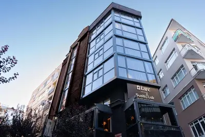 a tall building with glass windows on a street at Tare Houses in Istanbul