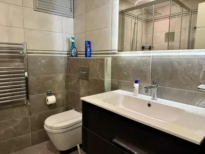 a bathroom with a sink and a toilet and a mirror at Bomonti 42 Suites in Istanbul