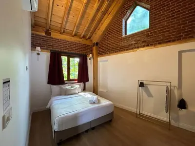 a bedroom with a bed in a room with a window at Villa Arancia Istanbul - Garden, BBQ, Sauna & Turkish Bath by the Tram in Fatih in Istanbul