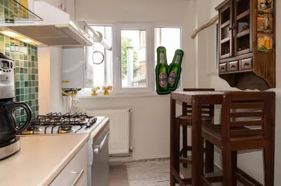 a kitchen with a stove and some chairs in it at An Unforgettable Experience in Istanbul