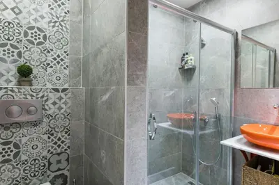 a bathroom with a glass shower with a sink at Stylish Duplex House with a Special Terrace in Istanbul