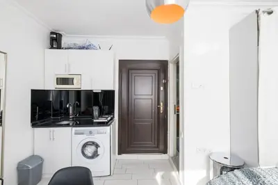 a kitchen with a washer and dryer in a room at Cute 1 Room w AC 300 meters to Istiklal Street in Istanbul