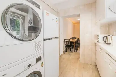 a kitchen with a washer and dryer in a room at Beautiful 2BR House w/AC 400meters Taksim Square in Istanbul