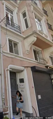 a woman walking out of a house with a mask on at Beautiful 2BR House w/AC 400meters Taksim Square in Istanbul