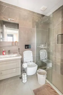 a bathroom with a toilet and a sink and a shower at Stylish 2BR and 3BR Izmit Apartments- Chic & Cozy in Çavuşçiftliği