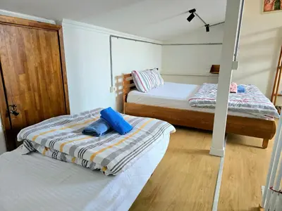 two beds in a small room with two beds sidx sidx sidx at Armel Homes Galata in Istanbul