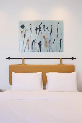 a bed with white pillows and a painting above it at Evra Suites Hotel in Istanbul