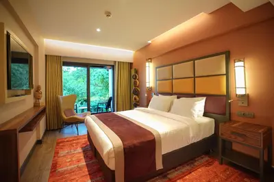 a hotel room with a large bed and a balcony at Sile Gonen Hotel in Sile