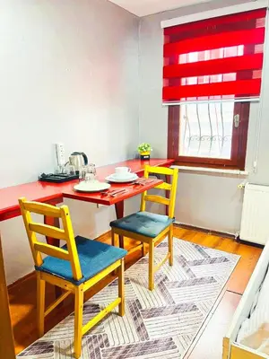 a kitchen with a table and two chairs and a table at Taksim Ottoman Style Hotel in Istanbul