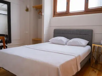 a bedroom with a large white bed with two pillows at Balat Tarihin içinden Pink Home 1 in Istanbul