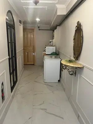 a hallway with a refrigerator and a table and a door at Balat Tarihin içinden Pink Home 1 in Istanbul