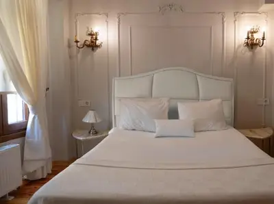 a bedroom with a large white bed with two pillows at Balat Tarih dokulu Pink Home 2 in Istanbul