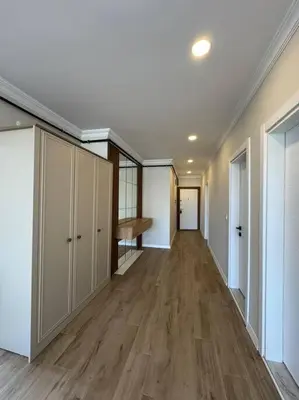 an empty hallway in a house with wooden floors at Luxurious 3BR Izmit Apartments- Mountain View in Çavuşçiftliği