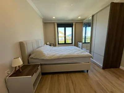 a bedroom with a bed and a large window at Luxurious 3BR Izmit Apartments- Mountain View in Çavuşçiftliği