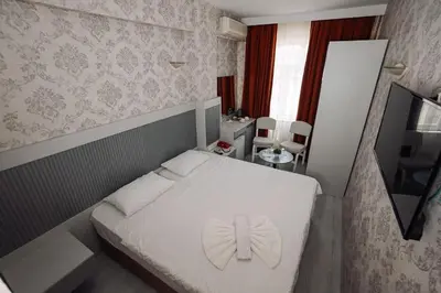 a bedroom with a white bed with a butterfly on it at Topkapi Golden Time Hotel in Istanbul