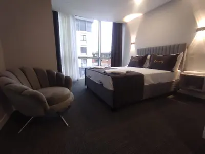 a bedroom with a bed and a chair and a window at Cevvo Hotel Pendik in Istanbul