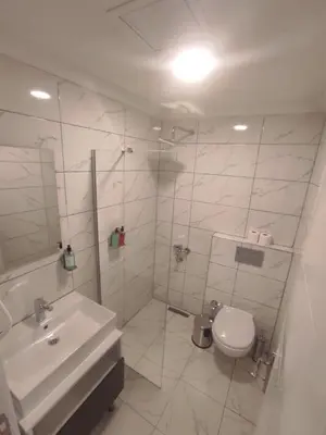 a white bathroom with a sink and a toilet at Cevvo Hotel Pendik in Istanbul