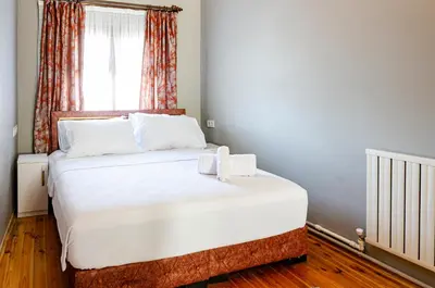 a bedroom with a bed with white sheets and a window at The Wall Private Mansion Kumkapı in Istanbul