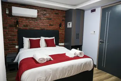a bedroom with a large bed with towels on it at mansion yellow hotel in Istanbul