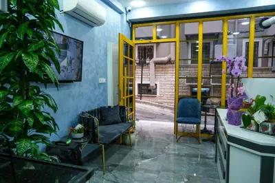 a room with a yellow door and two chairs at mansion yellow hotel in Istanbul