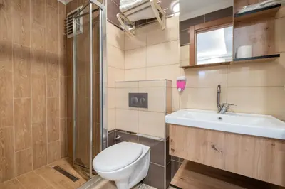a bathroom with a toilet and a sink and a shower at Fulya Süit Hotel in Istanbul