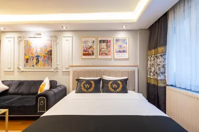 a bedroom with a bed and a couch at Fulya Süit Hotel in Istanbul