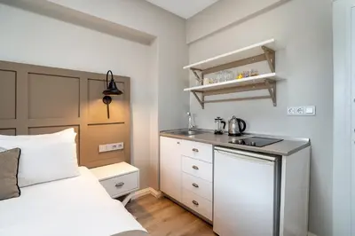 a small bedroom with a bed and a sink at Urban Quarters - Tepebaşı in Istanbul