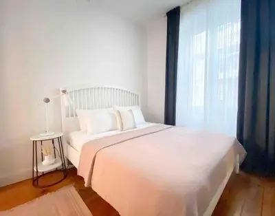 a white bed in a room with a window at Charming historical apartment in Galata in Istanbul