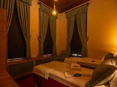a hotel room with two beds and curtains at Araz White House in Burgaz