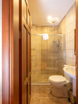 a bathroom with a toilet and a shower and a sink at Araz White House in Burgaz