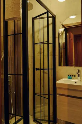 a bathroom with a glass door and a sink at Galata Calm Tale Hotel in Istanbul