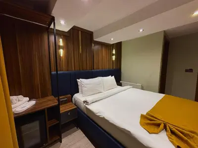 a bedroom with a large white bed and a desk at Galata Calm Tale Hotel in Istanbul