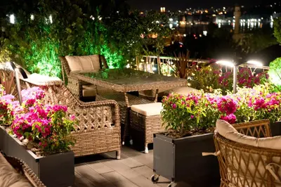 a patio with flowers and a table and chairs at Gzh Park Bosphorus in Istanbul