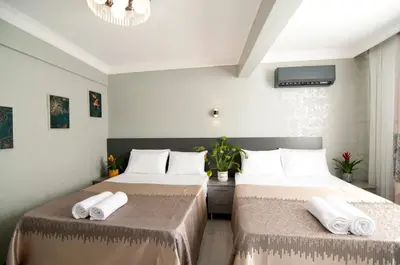 two beds in a hotel room with towels on them at Gzh Park Bosphorus in Istanbul