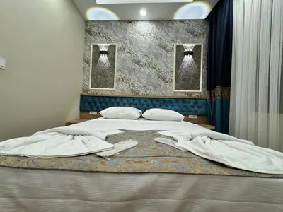 a bedroom with a bed with two towels on it at Riverside Hotel in Istanbul