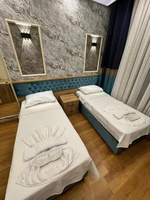 two beds in a room with two mirrors at Riverside Hotel in Istanbul