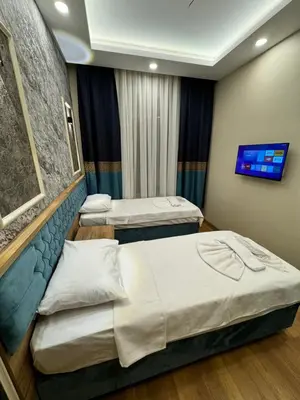 a hospital room with two beds and a tv at Riverside Hotel in Istanbul