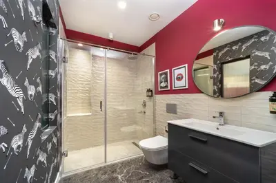a bathroom with a shower and a toilet and a sink at Siesta Hotel Bakırköy in Istanbul