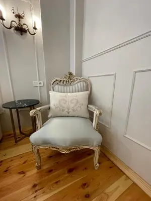 a white chair with a pillow in a room at Fatih Balatta Pink Home 3 in Istanbul