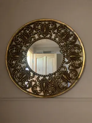a mirror with a gold frame hanging on a wall at Fatih Balatta Pink Home 3 in Istanbul