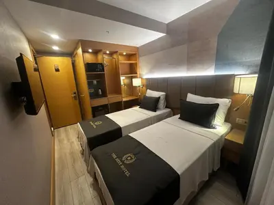 a small room with two beds and a kitchen at The Best Hotel İstanbul in Istanbul