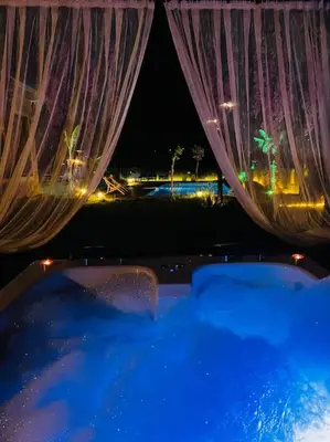 a view of a bath tub with curtains and lights at MEDASUİTE Stone House With Pool And Jacuzzi in Kandıra