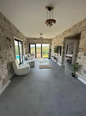 a large living room with a stone wall at MEDASUİTE Stone House With Pool And Jacuzzi in Kandıra