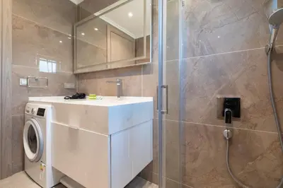 a bathroom with a washing machine and a shower at Mayer Skycon Residence Besiktas in Istanbul
