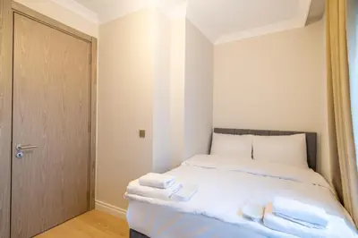 a bedroom with a bed with towels on it at Mayer Skycon Residence Besiktas in Istanbul